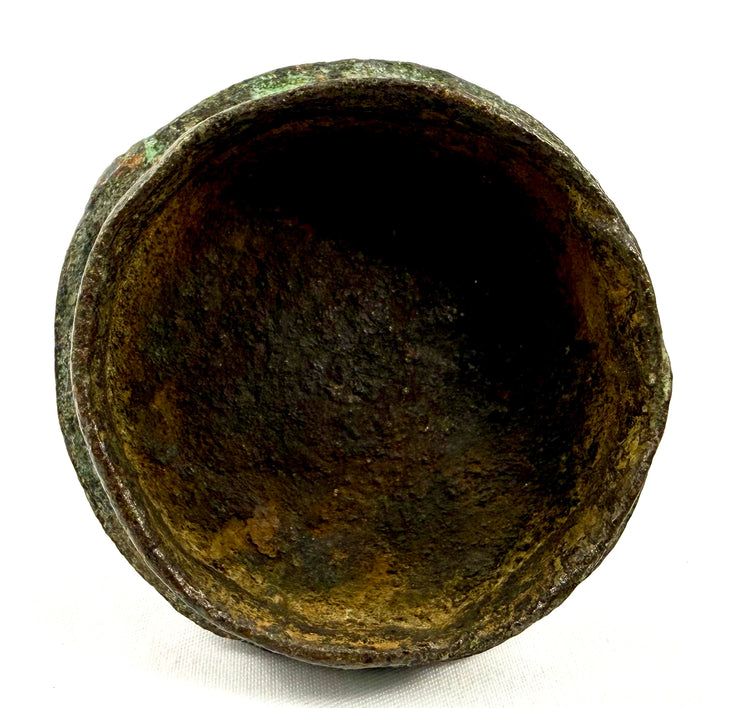 Dogon-attributed bronze vessel measuring approximately 7.5 inches tall, featuring a human-shaped lid finial and rounded decorated body.