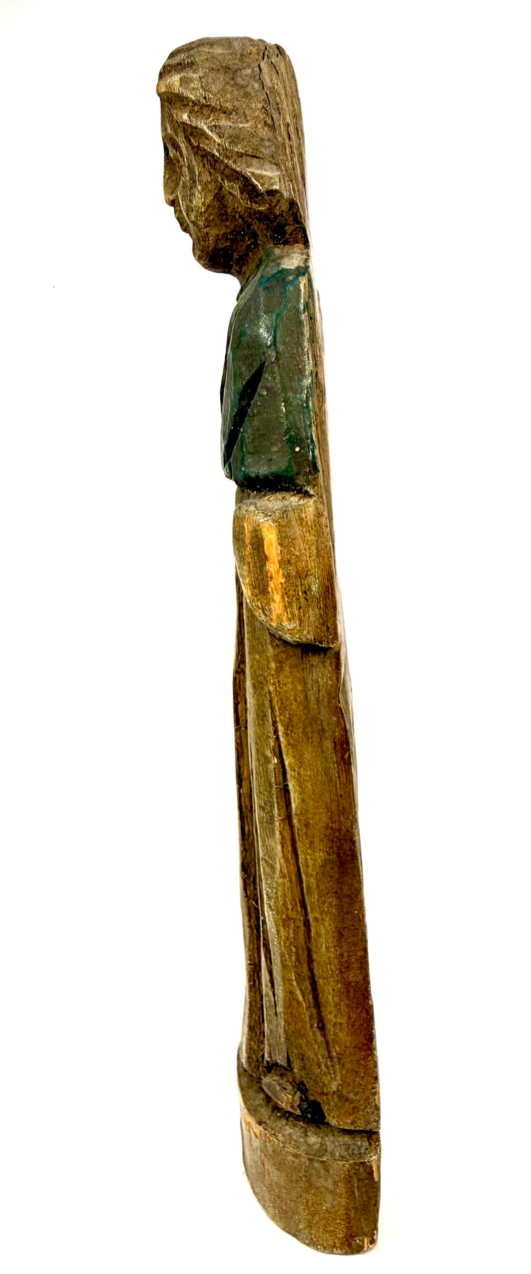 Left side view of weathered wooden folk art statue with remnants of green paint