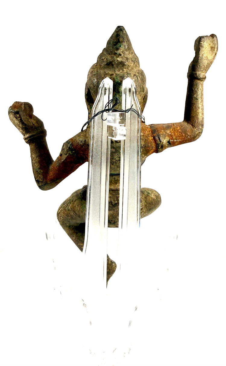 Top-down view of bronze statue with rust tones on acrylic stand