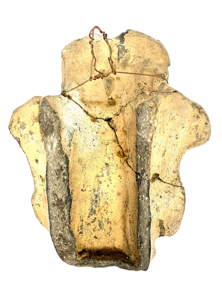 Back detail of ancient Mesoamerican artifact revealing hollow channel and copper wire frame