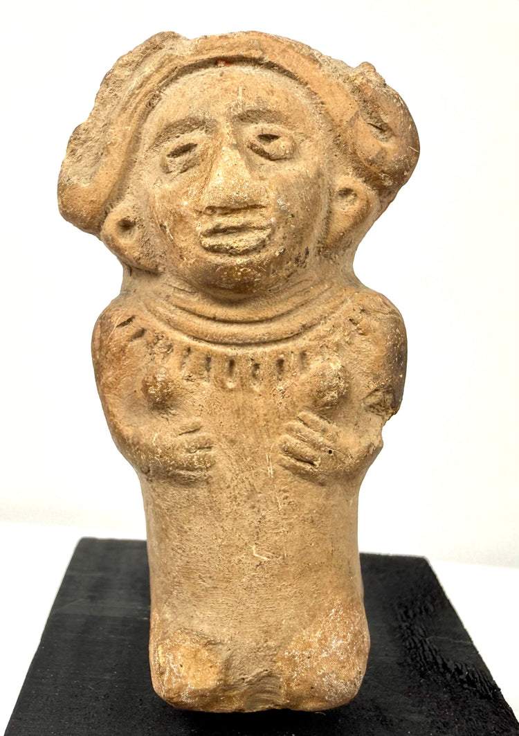 Pre-Columbian Veracruz seated female figurine displaying defined breasts, raised hands, and a decorative pectoral collar.