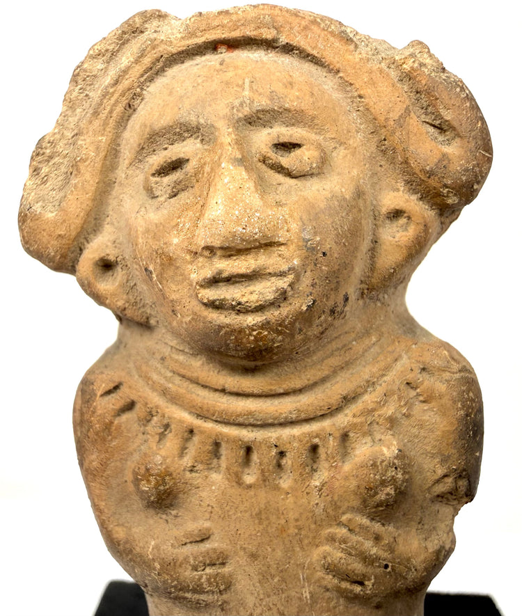 Close-up of ancient Veracruz ceramic figurine face and torso incised details