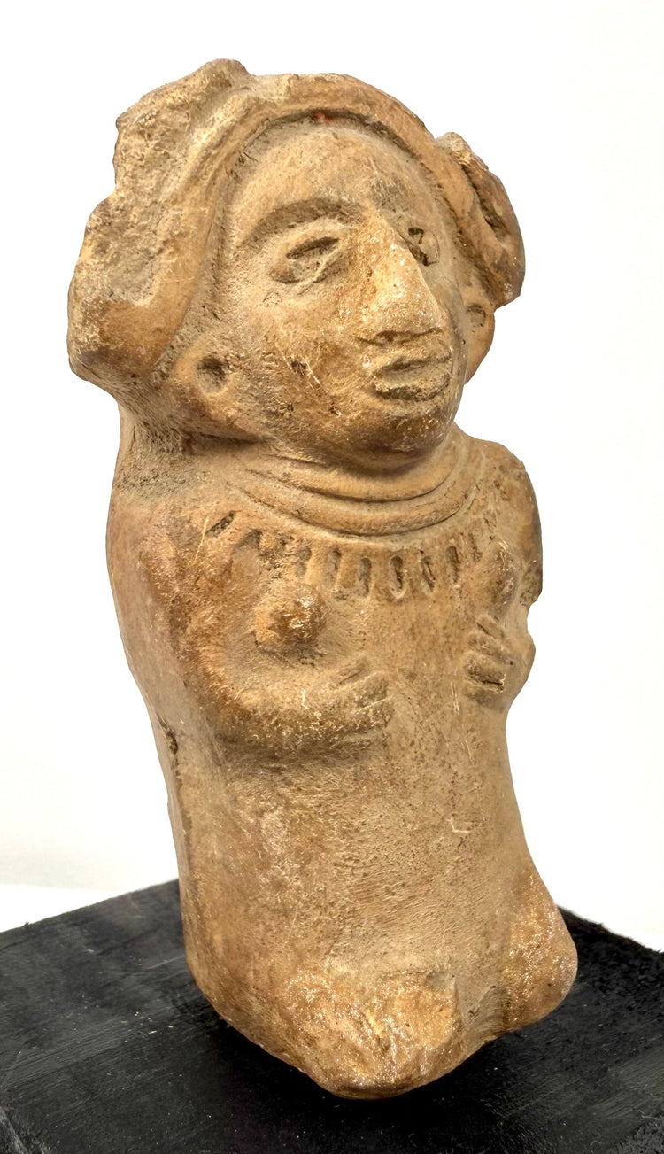 Ancient Mexican terracotta female figure with a broad flaring headdress, rounded body, and detailed ceremonial adornments.