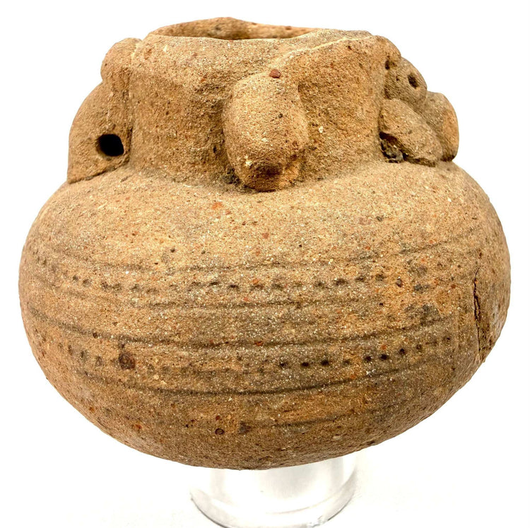 Ancient unglazed earthenware vessel with incised lines and knob handles
