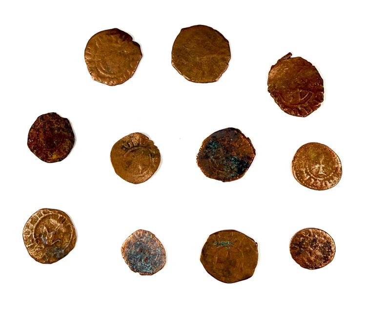 Historical rough-hewn medieval coins with reddish-brown tones