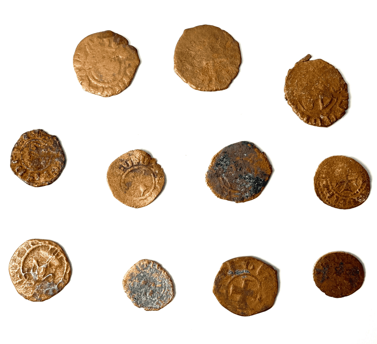 Antique bronze currency set with hammered textures and verdigris