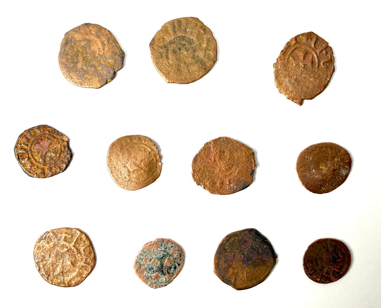 Weathered medieval coins displaying remnants of engravings