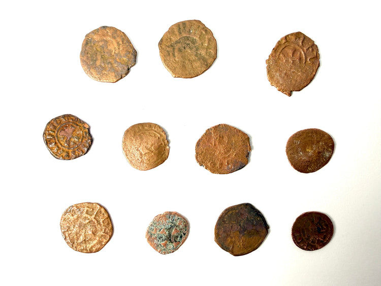 Group of crude medieval coins with green mineral deposits