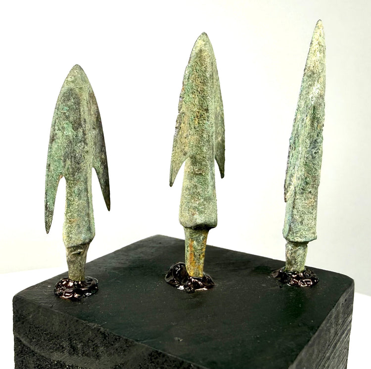 Side profile of barbed bronze spearheads showing hollow socket bases