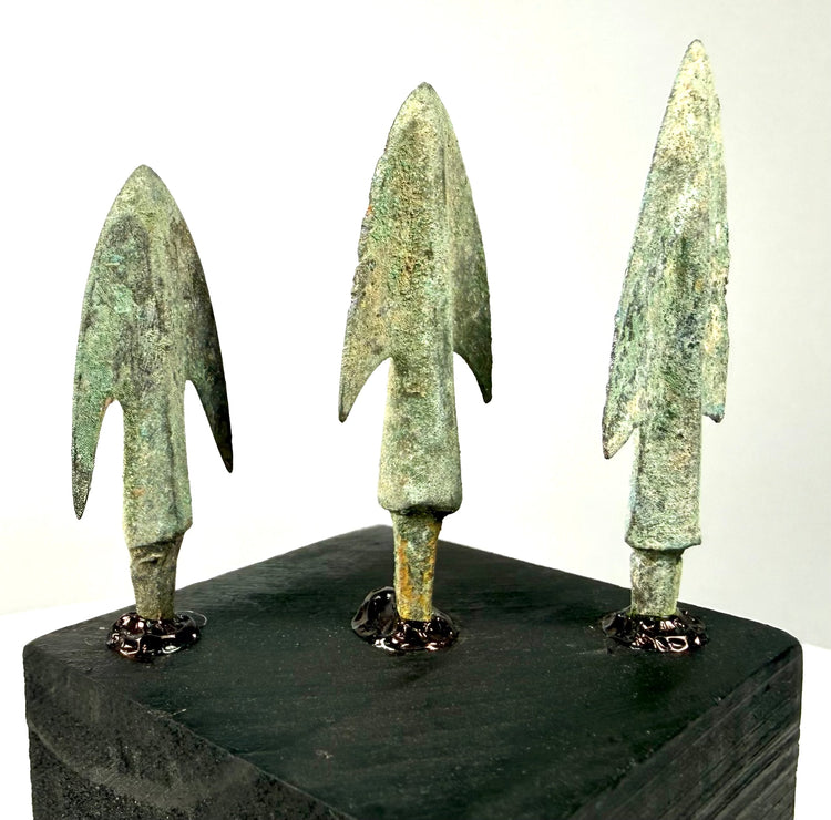 Close-up side view of bronze points showcasing tapering tangs