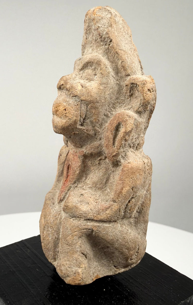 Ancient Northern Indian clay figurine with an elongated head, simplified body proportions, and weathered terracotta surfaces.