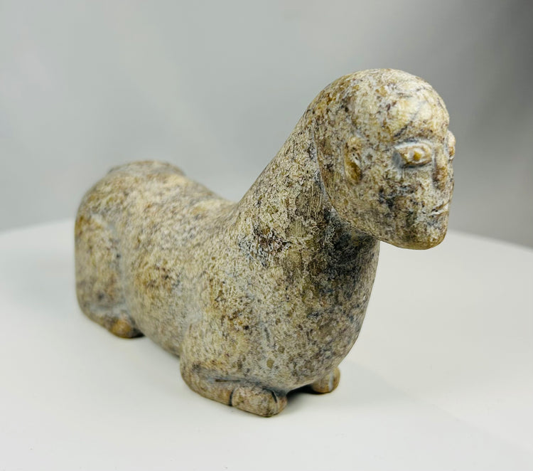 Tribal African stone sculpture depicting abstract animal figure with patina