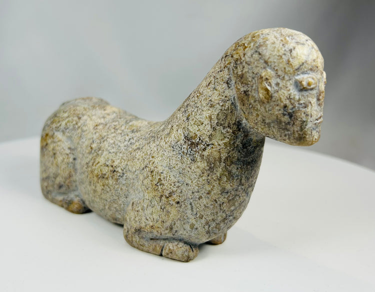 Hand carved tribal stone figure with abstract animal representation