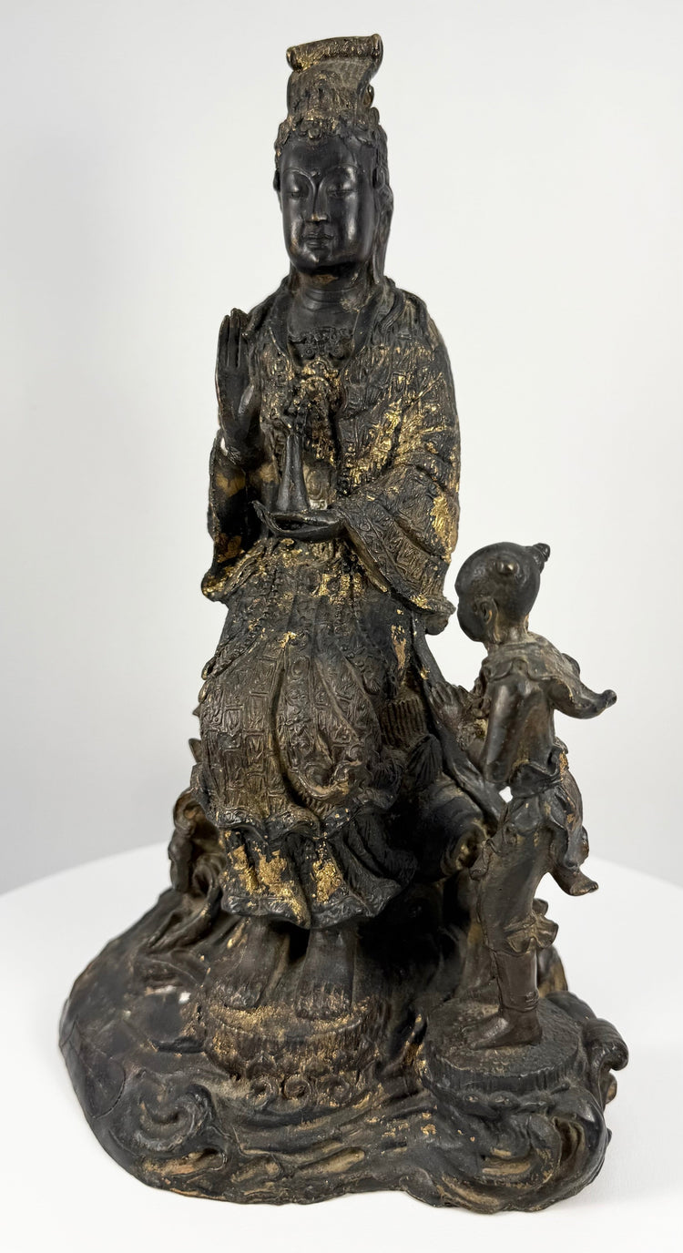 Full frontal view of antique gilt bronze Guanyin holding vase on lotus base