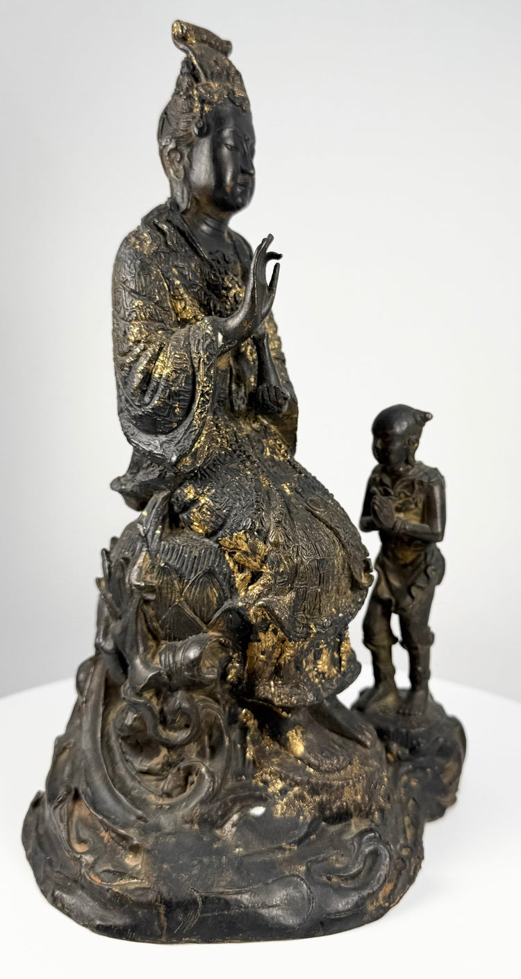Front three-quarter view of antique gilt bronze Bodhisattva with attendant