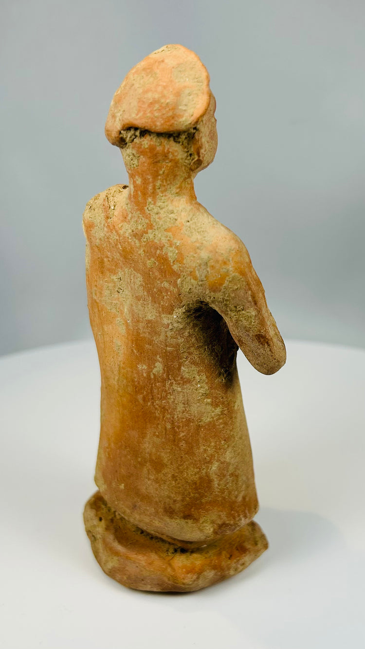 Folk-style terracotta sculpture with cap-like headdress