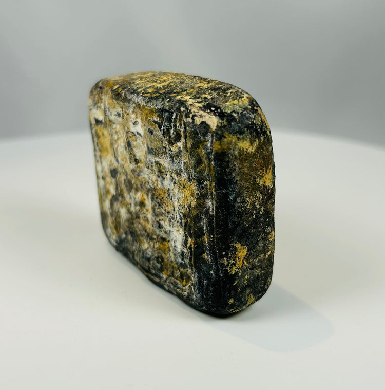 Carved stone tablet with geometric motifs and archaeological wear