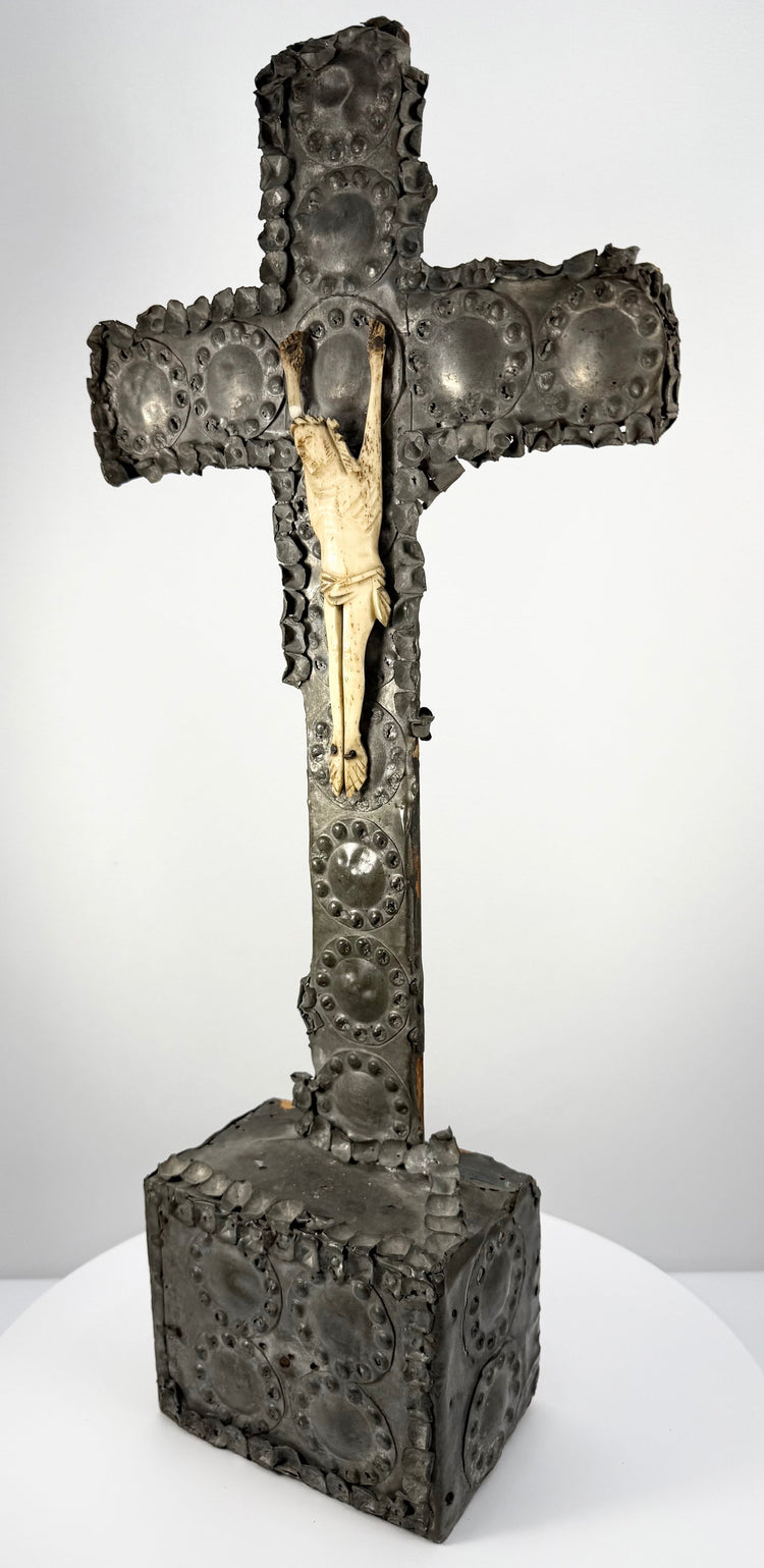 Antique Spanish Colonial wooden crucifix adorned with decorative tin metalwork and traditional Christian religious symbolism.