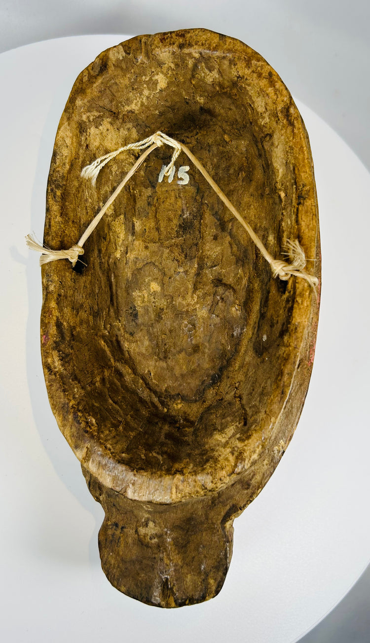 Vintage African mask with elongated form and natural wear