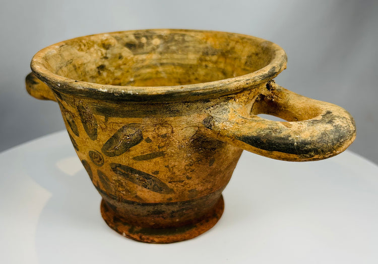 Etruscan drinking cup with geometric rosette design and aged patina
