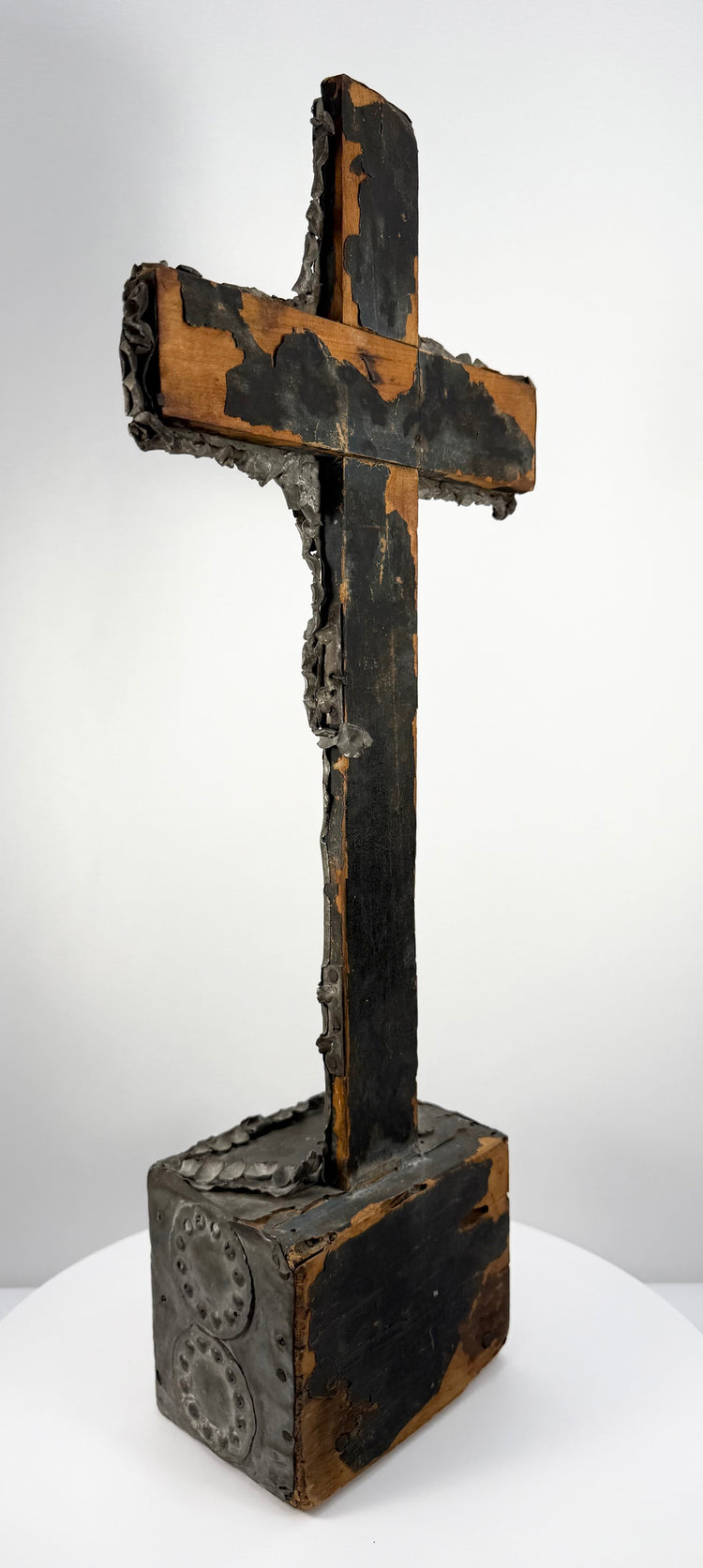 18th–19th century Spanish Colonial crucifix with hand-hammered tin repoussé, aged wooden construction, and natural oxidation.