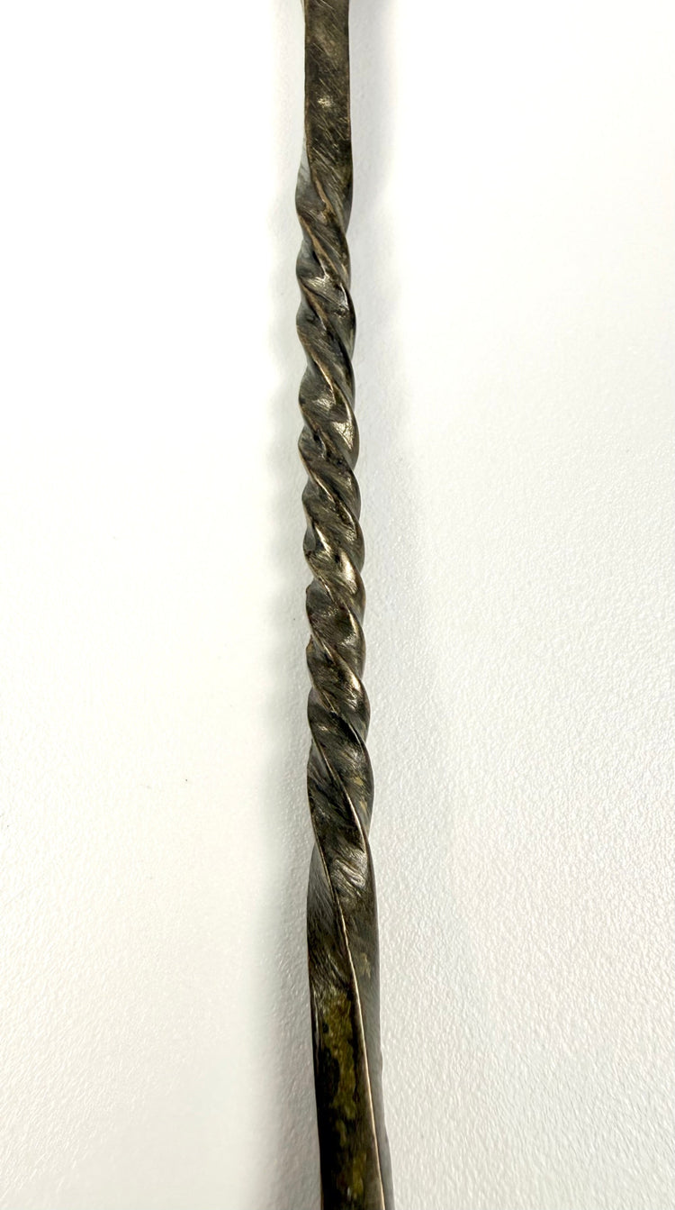 Ancient Roman bronze spoon from the Mediterranean region, featuring traditional metalwork and natural surface encrustation.