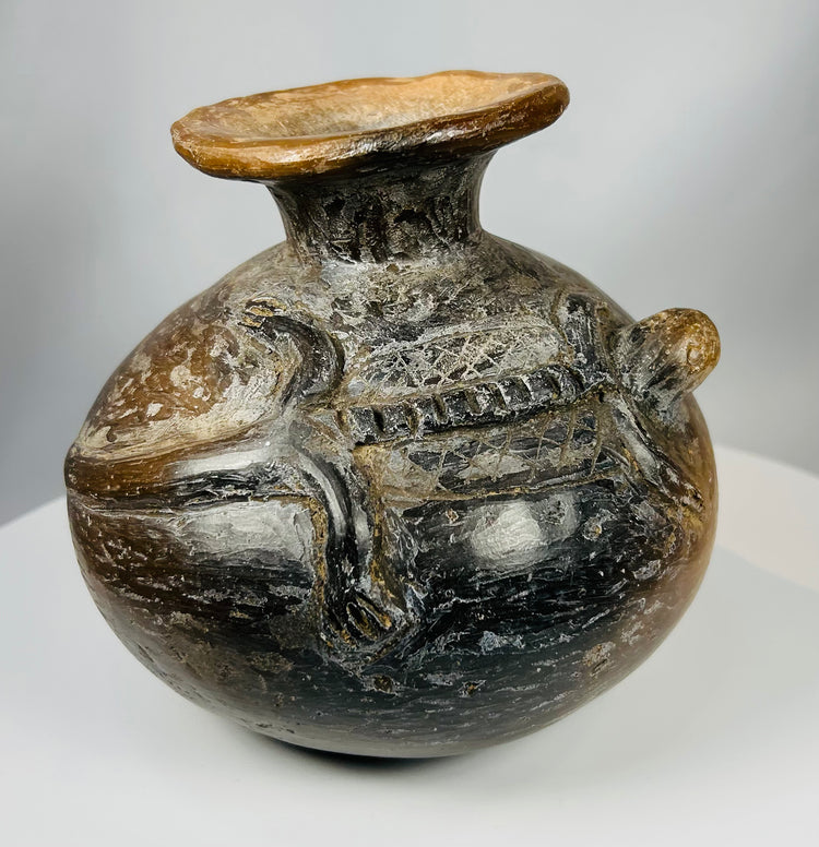 Pre-Columbian ritual container with animal relief and burnished clay