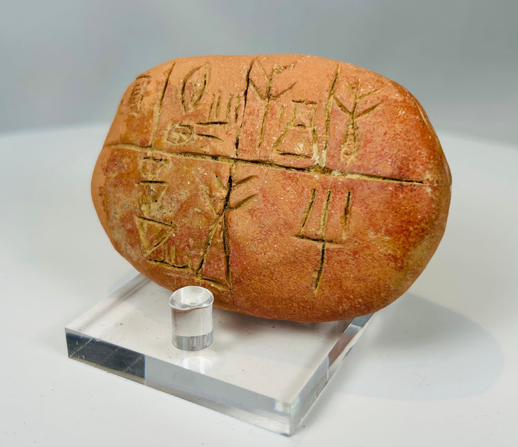 Mesopotamian terracotta tablet with incised writing and aged surface