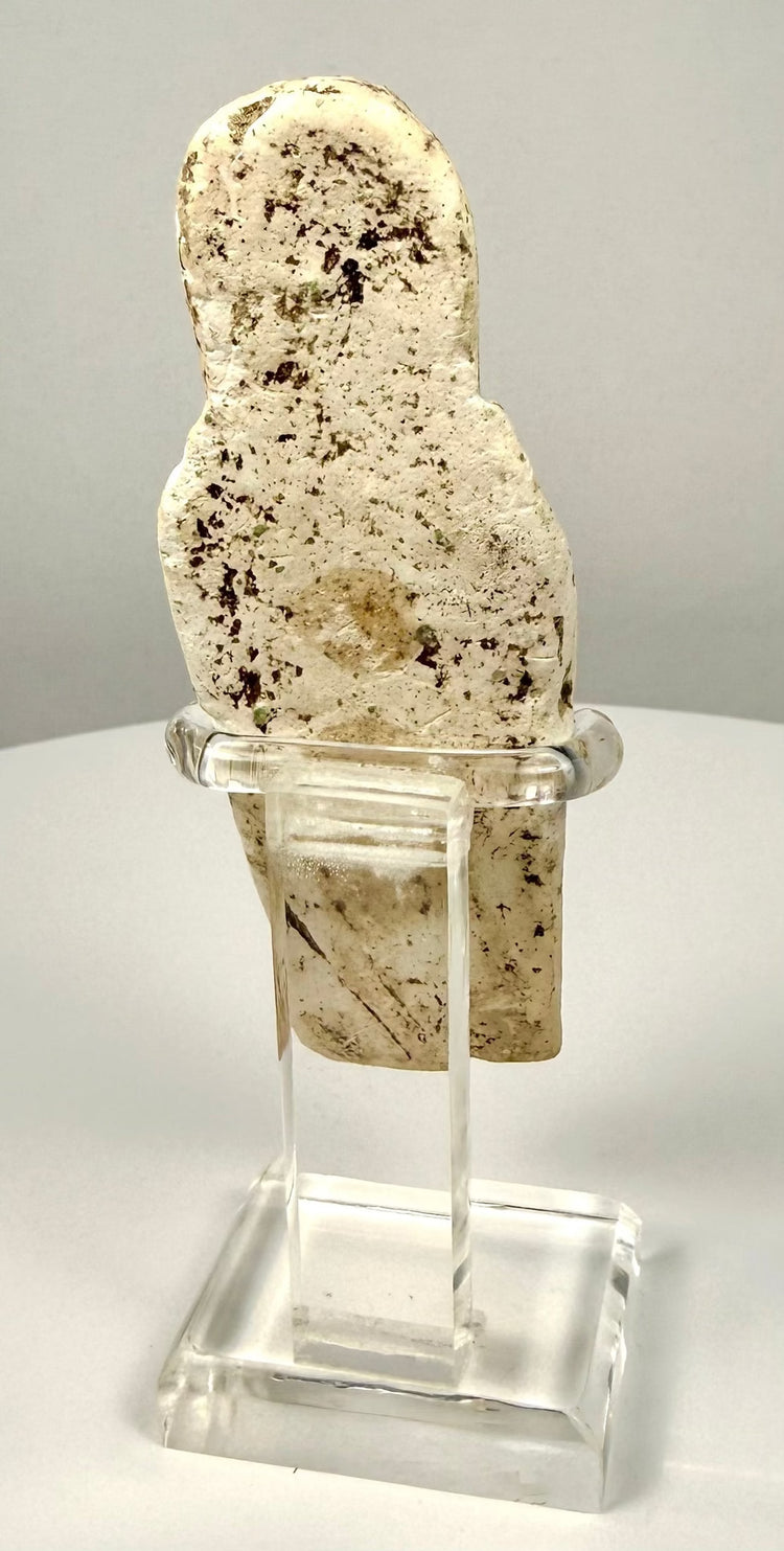 Ancient Egyptian limestone ushabti displaying weathered facial features, a prominent headdress, and an inscription panel along the lower body.