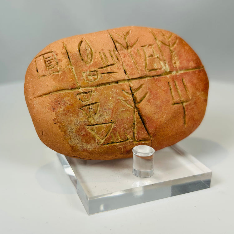 Ancient clay tablet with cuneiform script and archaeological wear