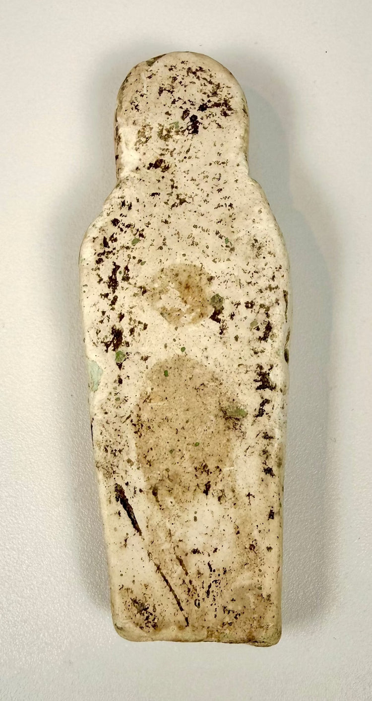 Ancient Egyptian ushabti funerary attendant, approximately 2,700–3,600 years old, featuring folded hands, a tripartite wig, and worn hieroglyphic decoration.