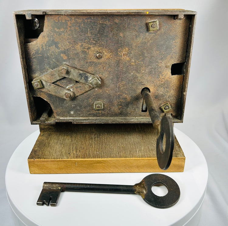 Victorian rim lock mechanism with exposed internal components and key