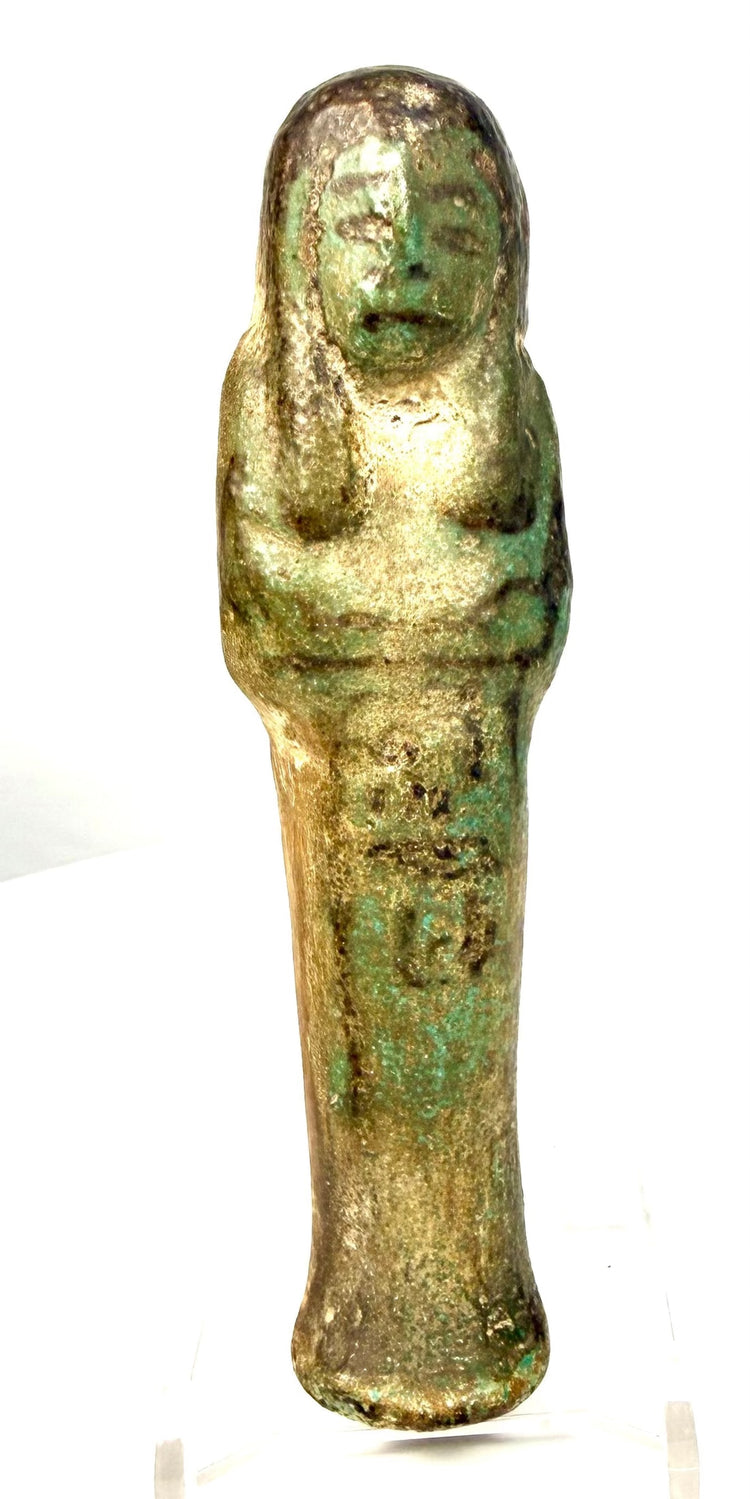 Ancient Egyptian funerary attendant showing turquoise-green glaze, brown discoloration, and age-related surface abrasion.