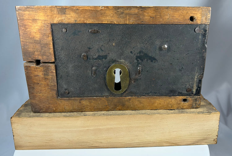 Wooden box lock with brass keyhole escutcheon and iron plates