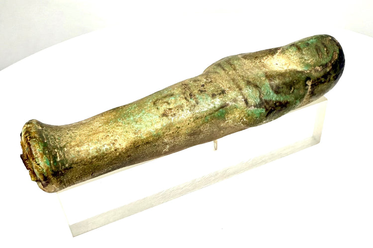 Ancient Egyptian faience funerary figure featuring black-painted facial details and traces of original decorative pigment.