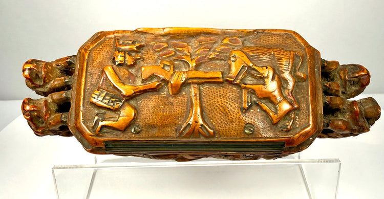 Victorian-era Italian wooden tobacco box with an elongated rectangular body, hinged lid, and projecting sculptural beast-head terminals.