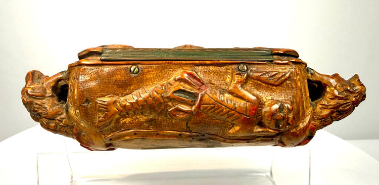 Italian carved wood snuff box displaying an intricate hunting scene with human figures, animals, a firearm, and detailed foliage.