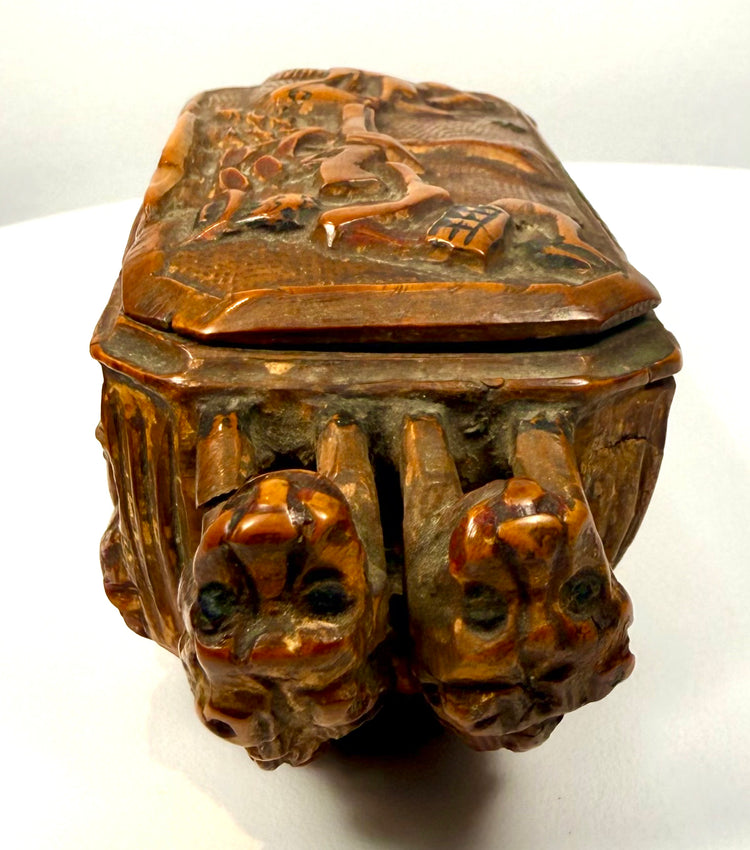 Late Victorian Italian hardwood snuff box displaying intricate side carvings of mythical creatures, marine motifs, and decorative figures.