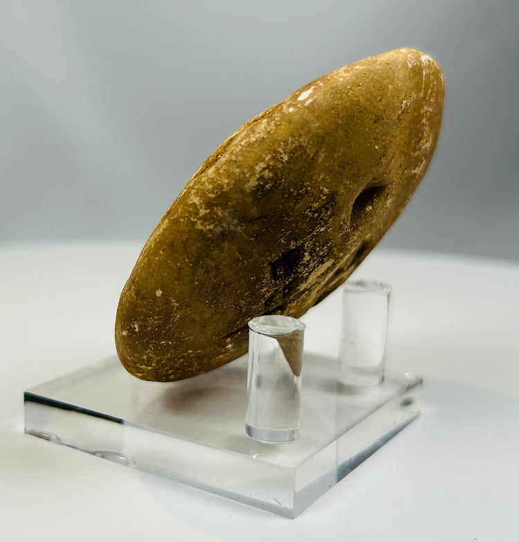 Historic stone seal with abstract pattern and smooth surface wear