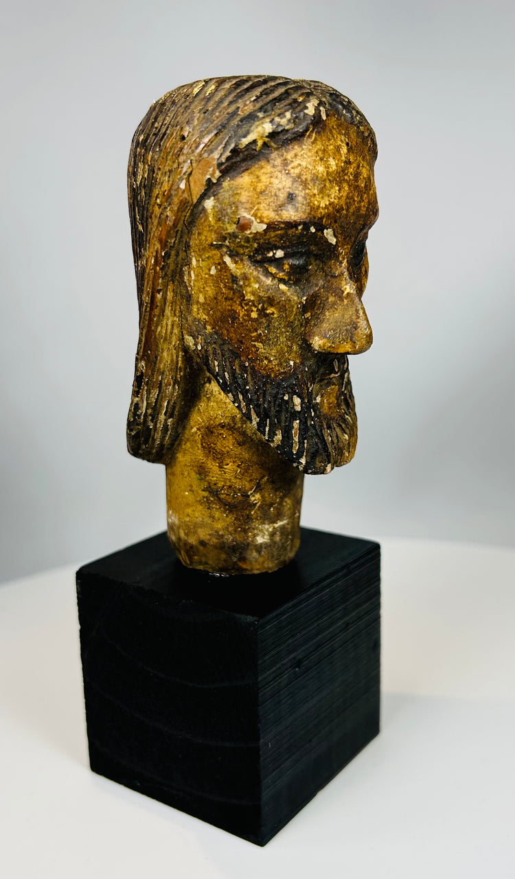 European devotional sculpture of Christ with aged paint remnants