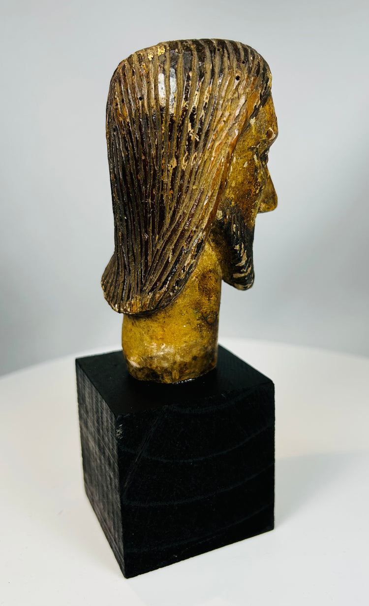 Religious wood sculpture of Christ with long hair and beard