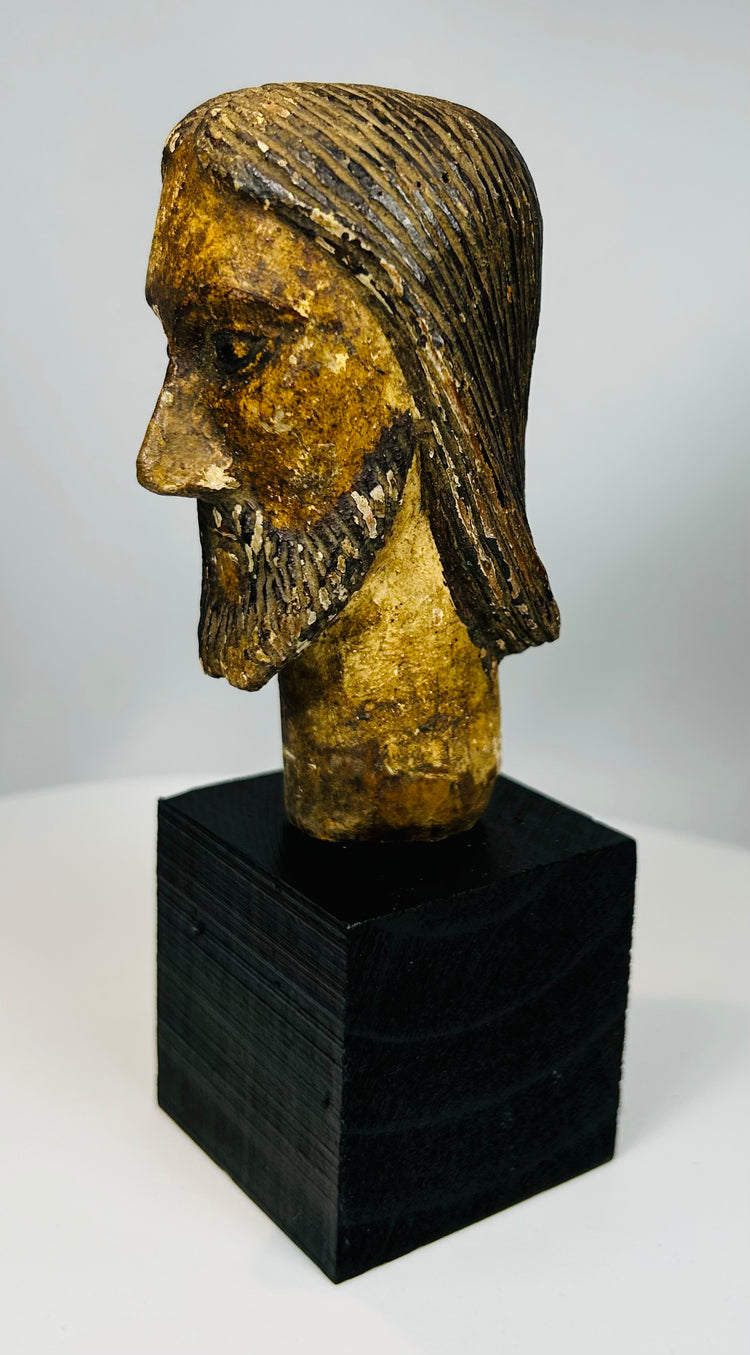 Historic wooden devotional sculpture with detailed beard carving