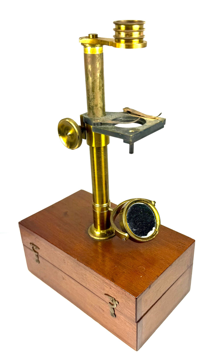 19th-century dissecting microscope featuring an adjustable brass-mounted illuminating mirror positioned beneath the specimen stage.