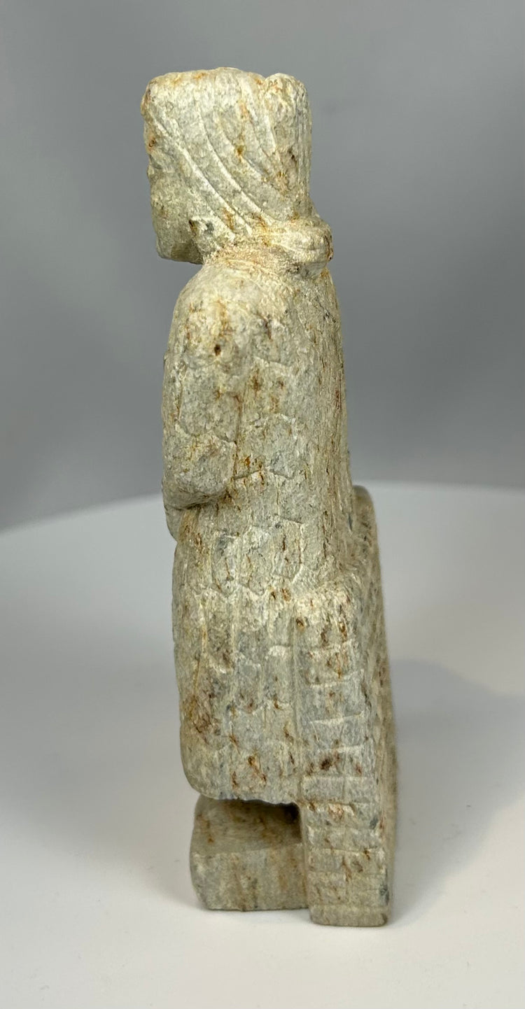 Early Mesopotamian votive figure holding offering vessel