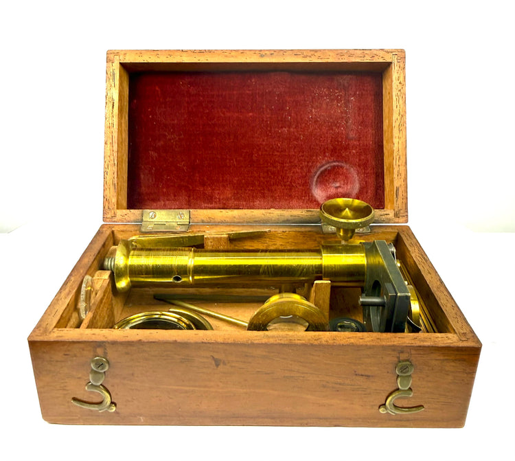 Victorian brass field-type microscope collection with mahogany case, precision optical accessories and historical prepared insect specimens.