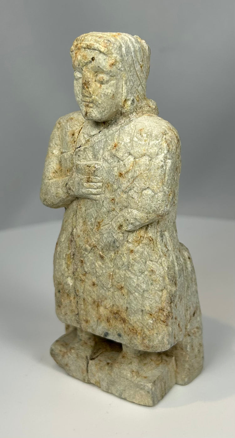 Ancient temple votive sculpture representing worshipper in prayer