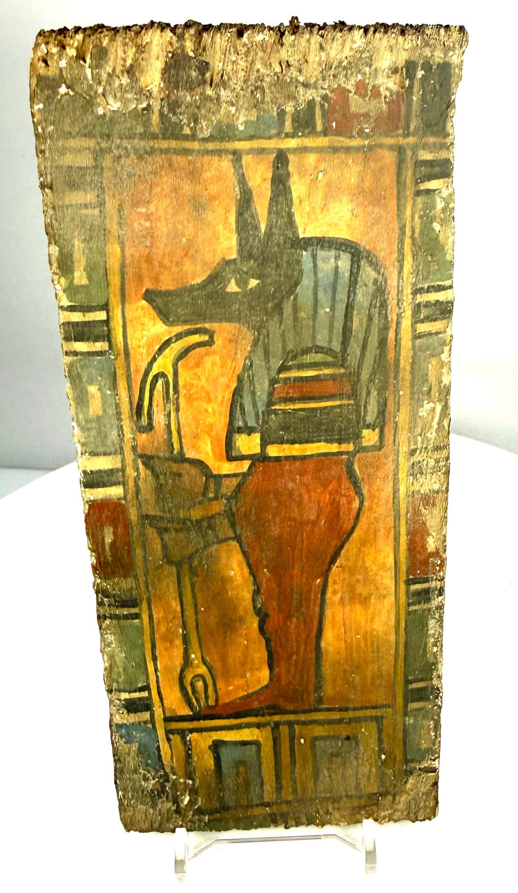 Ancient Egyptian funerary panel displaying Duamutef, one of the Four Sons of Horus, surrounded by surviving polychrome decoration.