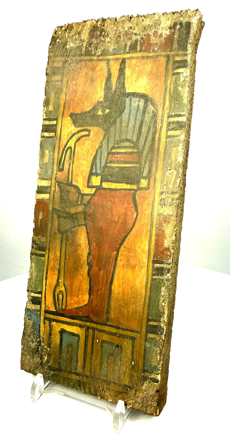Ptolemaic Egyptian wooden panel featuring Duamutef's elongated black muzzle, pointed jackal ears, and detailed striped headdress.