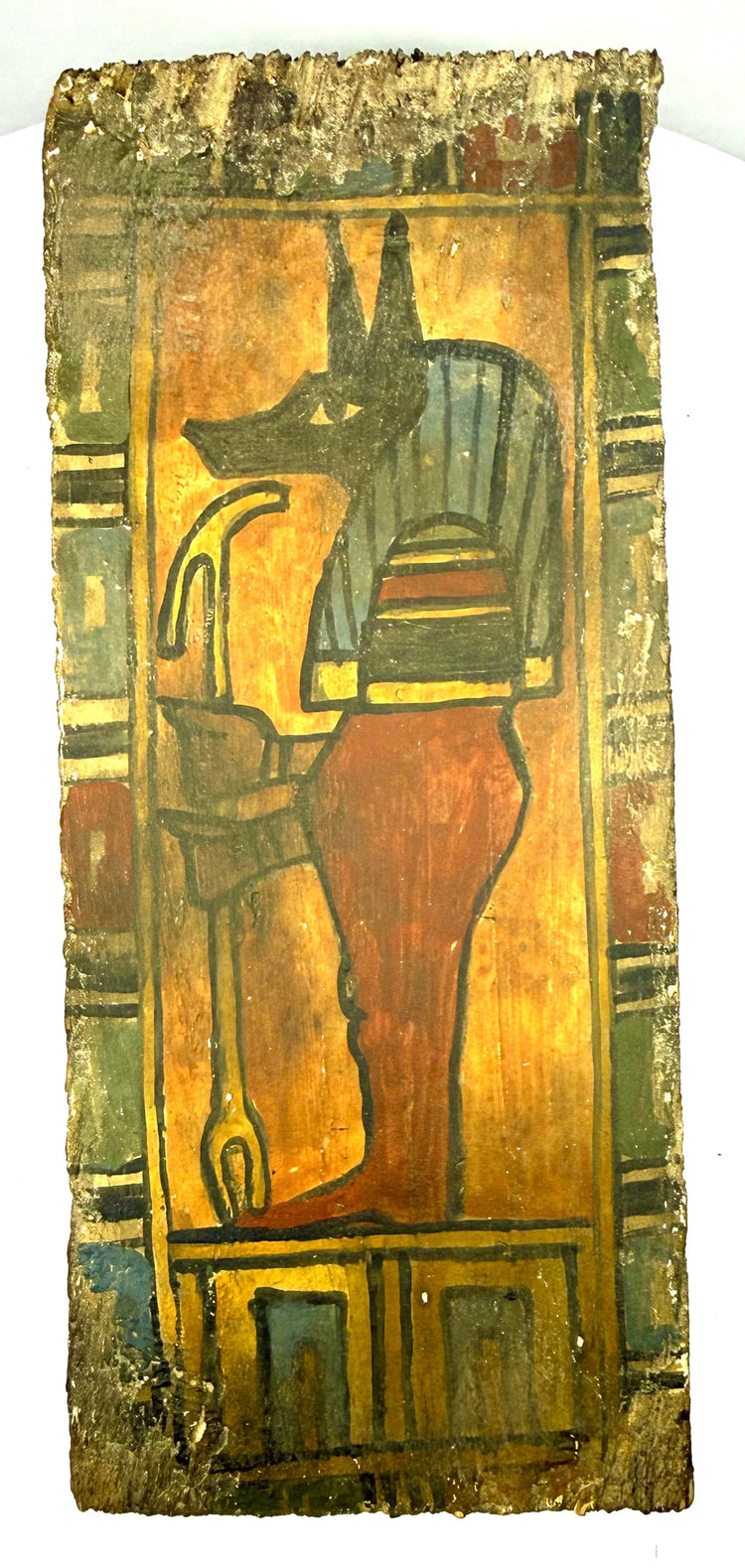 Ptolemaic Egyptian painted wooden panel depicting the protective deity Duamutef with multicoloured geometric borders and surviving funerary symbolism.