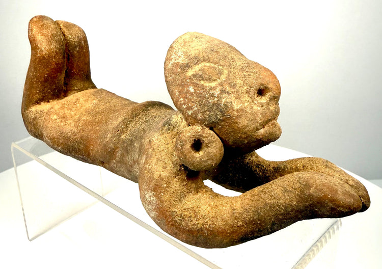 Coastal Ecuadorian-style ceramic sculpture featuring prominent circular earspools with central perforations and expressive facial modelling.
